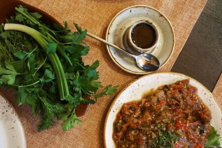 Salad and dishes on the table in the restaurantの写真素材