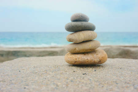 beautiful pyramid of stones on the beachの写真素材