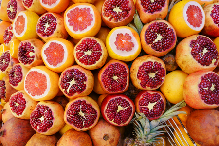 delicious and healthy fruit pomegranates and grapefruits in the bazaarの写真素材