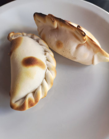 Pies in a white plate on a wooden table. Selective focus.の写真素材
