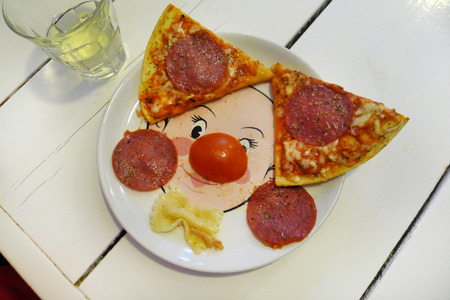 pizza on funny plate on table for a child to eatの写真素材