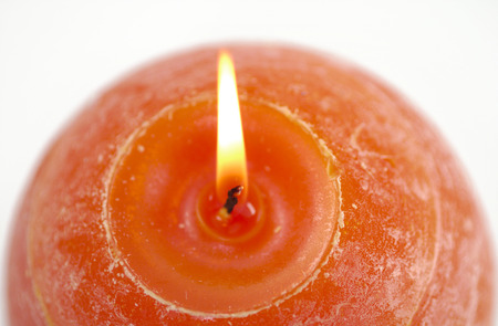 Orange round candles on a white backgroundの写真素材