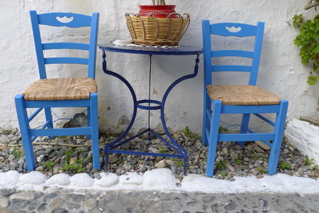 Two chairs outside a Greek restaurant, in te traditional blue andの写真素材