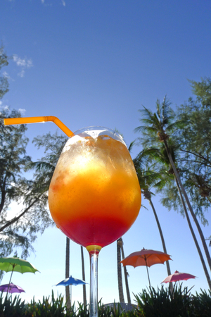 tequila sunrise at seaside Kho Khood Thailand with palmtreesの写真素材