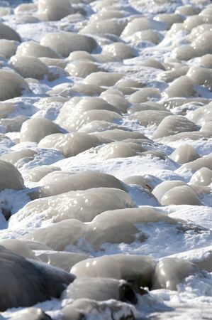 frozen ice on  boulders, in The Netherlands