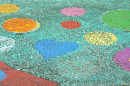 colorful painted figures  yellow orange blue and green on streetの写真素材