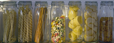 assortment Italian pasta in long glass potsの写真素材