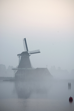 windmills in morning fog the Netherlands, Zaanse Schansの写真素材