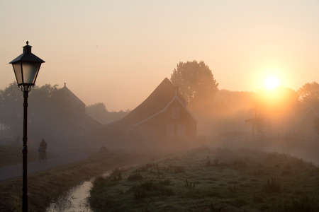 biking trough Zaanse Schans The Netherlands in sunriseの写真素材