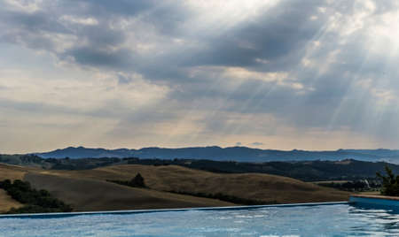 Swimming pool with view at beautiful landscape of Tuscany, Italy