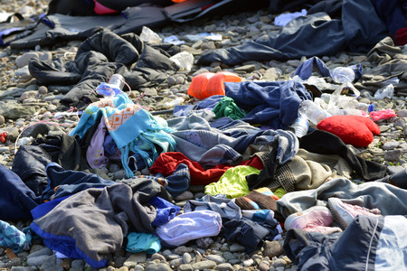 LESVOS, GREECE OCTOBER 24, 2015: Lifejackets, rubber rings an pieces of the rubber dinghys discarded on a beach near Molyvos. Eftalou and Skala Sikaminia. Lesvos has been a hot spot for migrants and refugees arriving in inflatable boats from Turkey.のeditorial素材