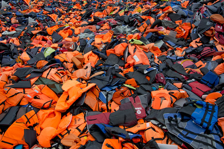 LESVOS, GREECE February 21, 2016: Lifejackets, rubber rings an pieces of the rubber dinghies left by refugees are making a mountain in Eftalou. Lesvos has been a hot spot for refugees.のeditorial素材