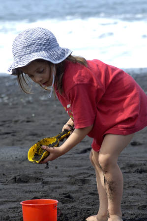 Puerto naos, La Palma 29-March-2005: Child playing on the beach with black sandのeditorial素材