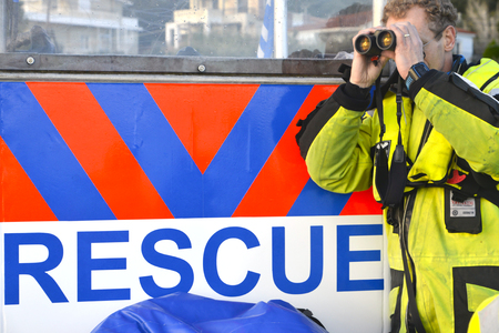Mytilene, Lesvos, Greece, 05-March-2016: A volunteer from BRF a Dutch help organisatuion is looking out for refugees with his binoculars.のeditorial素材