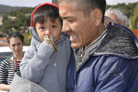 Mytilini, Lesvos, Greece, 03-March-2016: Refugees child arriving at Lesvos. After they flee from their home country. They travel from Turkey to Greece to get to Europe.のeditorial素材