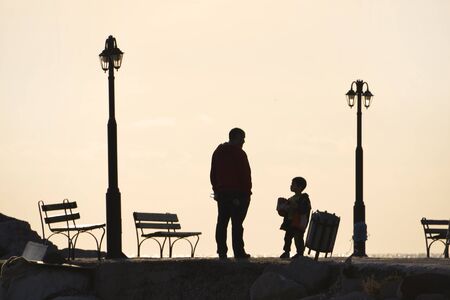 father and child walking at pier, Molivos harbor Lesvosのeditorial素材
