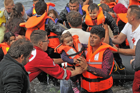 LESVOS, GREECE october 20, 2015: Refugees arriving in Greece in dingy boat from Turkey. These Syrian, Afghanistan and African refugees land their boat at the North coast of Lesvos near Molyvos, Eftalou and Skala Sikaminiaのeditorial素材
