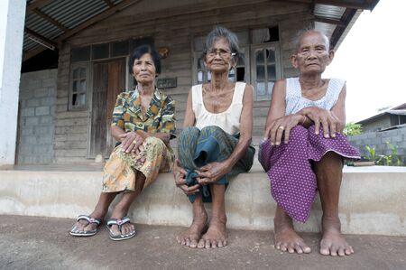 Thailand-may 28. Traditional village in North Thailand with three woman in front of there houses 28-05-11のeditorial素材