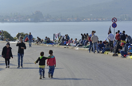 Lesvos, Greece- October 16, 2015. Refugee migrants, arrived on Lesvos in inflatable dinghy boats, they stay in refugee camps waiting for the ferry to mainland Greece continuing their journeys through Europe to seek asylum.のeditorial素材