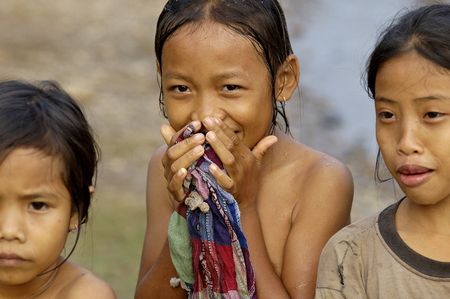 Luang Prabang, Laos, oct 30, 2007. Smiling Laos girls in a traditional village along the Mekong river were they wash every dayf 30-10-2007のeditorial素材