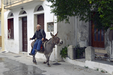 Greek man on donkey in the picturesque town of Plomari,のeditorial素材