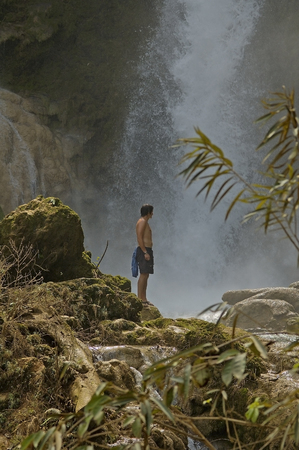Man is looking at the Kuang Si waterfall Laosのeditorial素材