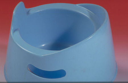 A blue's children potty isolated against a red background.の写真素材