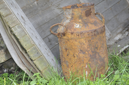 Old vintage milbins reflecting in the waterの写真素材