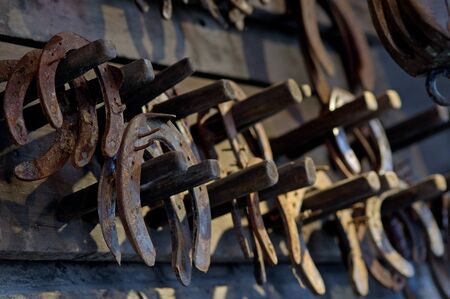 Brown rusty antique horseshoes in a barnの写真素材