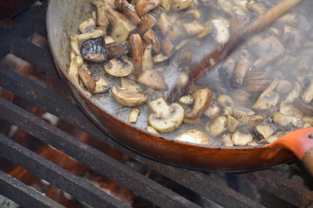 Baking mushrooms outside in the garden kitchenの写真素材