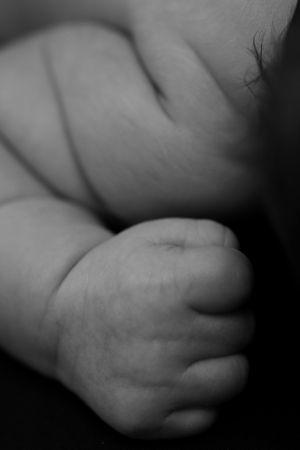 Beautiful baby hand  isolated on a black backgroundの写真素材