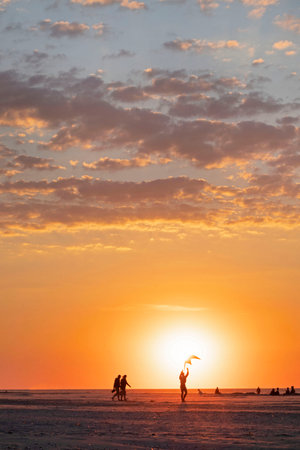 Ameland-The Netherlands-13-08-2022: Boy flying a kite at the beach.のeditorial素材
