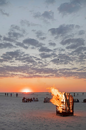 Ameland-The Netherlands-13-08-2022: Fire on the beach by sunset.