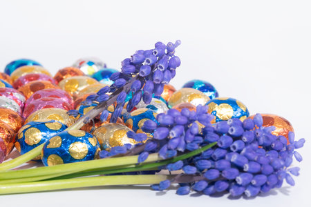 Easter eggs and a blue grape hyacinth flower displayed on a table