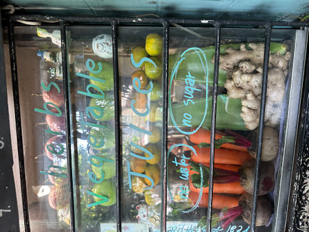 A vibrant fruit stand featuring a sign that reads fresh fruit shakeの写真素材