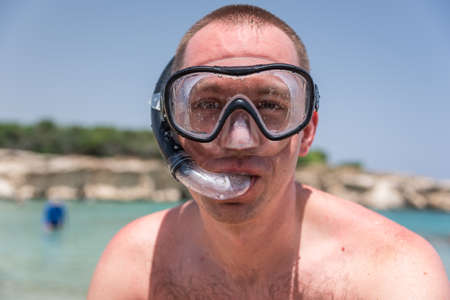 Man with diving mask at the seaの写真素材