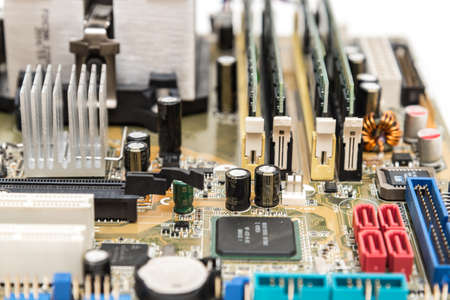 Close-up on a modern PC motherboard and it's electronics components, isolated