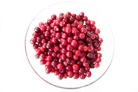 Plate of fresh washed drilled cherries on a glass plate, isolated.