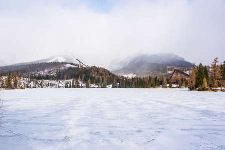 Frozen lake and ski-jump in background, Strbskie Pleso, Slovakiaの写真素材