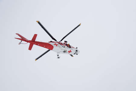Rescue helicopter in action in high mountainsの写真素材
