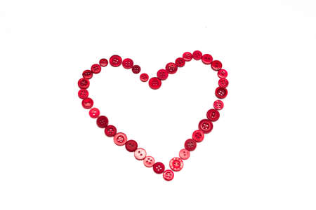 Heart shape made of red buttons of different sizeの写真素材