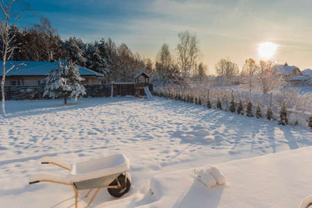 Backyard covered with snow on a sunny winter morningの写真素材