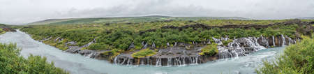 Hraunfossar waterfall pouring into the river from HvÃtÃ¡ ledges of lava rock, located in Western Icelandの写真素材