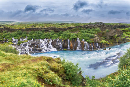 Hraunfossar waterfall pouring into the river from HvÃtÃ¡ ledges of lava rock, located in Western Icelandの写真素材