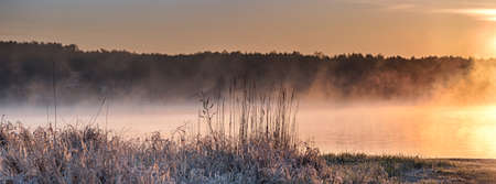 Magical sunrise with light fog over a lake (Zalew Chancza, Poland)の写真素材
