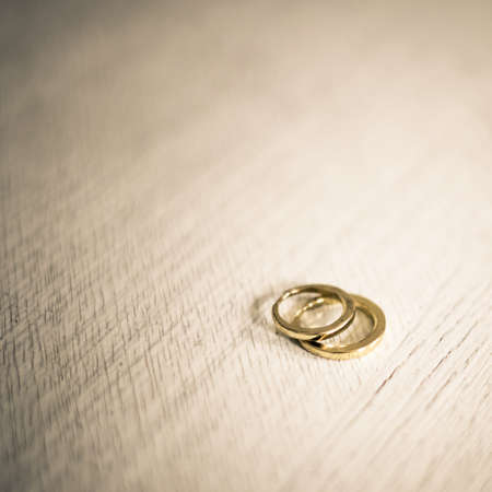 A pair of golden wedding rings, macro shot with very shallow depth of fieldの写真素材