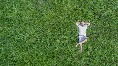 Man lying on a grassの写真素材