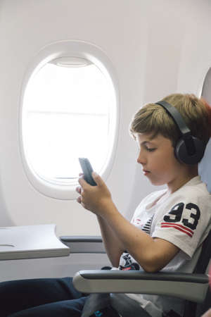 Boy listening to music in a plane