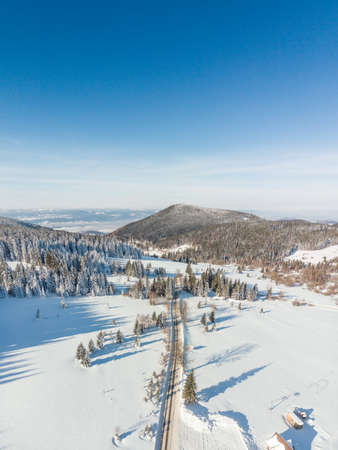 A road to mountains covered with snowの写真素材