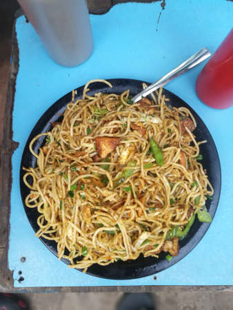 Chicken noodles with tomato and chili sauceの写真素材